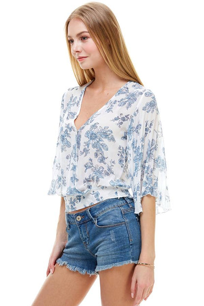 TOP FLORAL DE MANGA LARGA CON SOBREPELLEZ