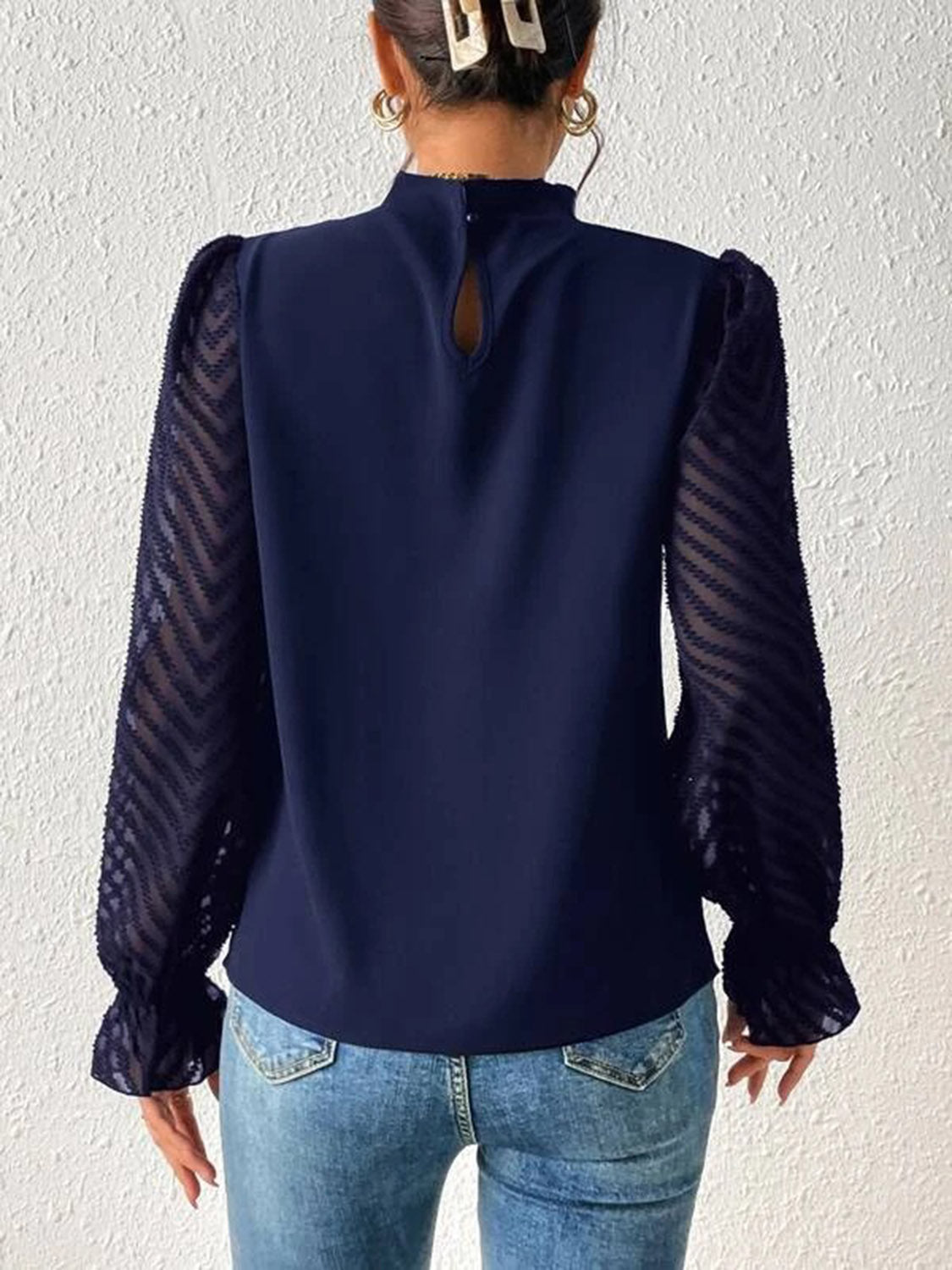 Blusa con cuello alto y mangas con volantes