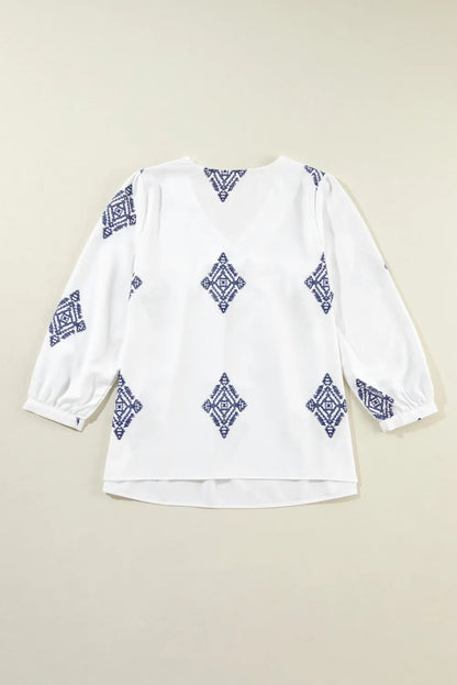 Blusa estampada con cuello en V y mangas tres cuartos