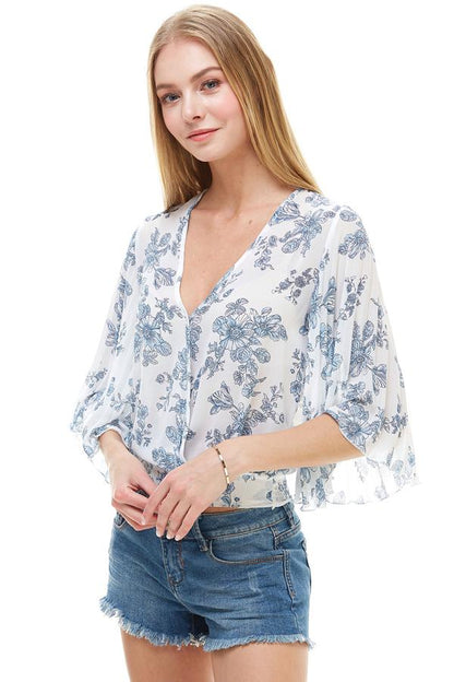TOP FLORAL DE MANGA LARGA CON SOBREPELLEZ